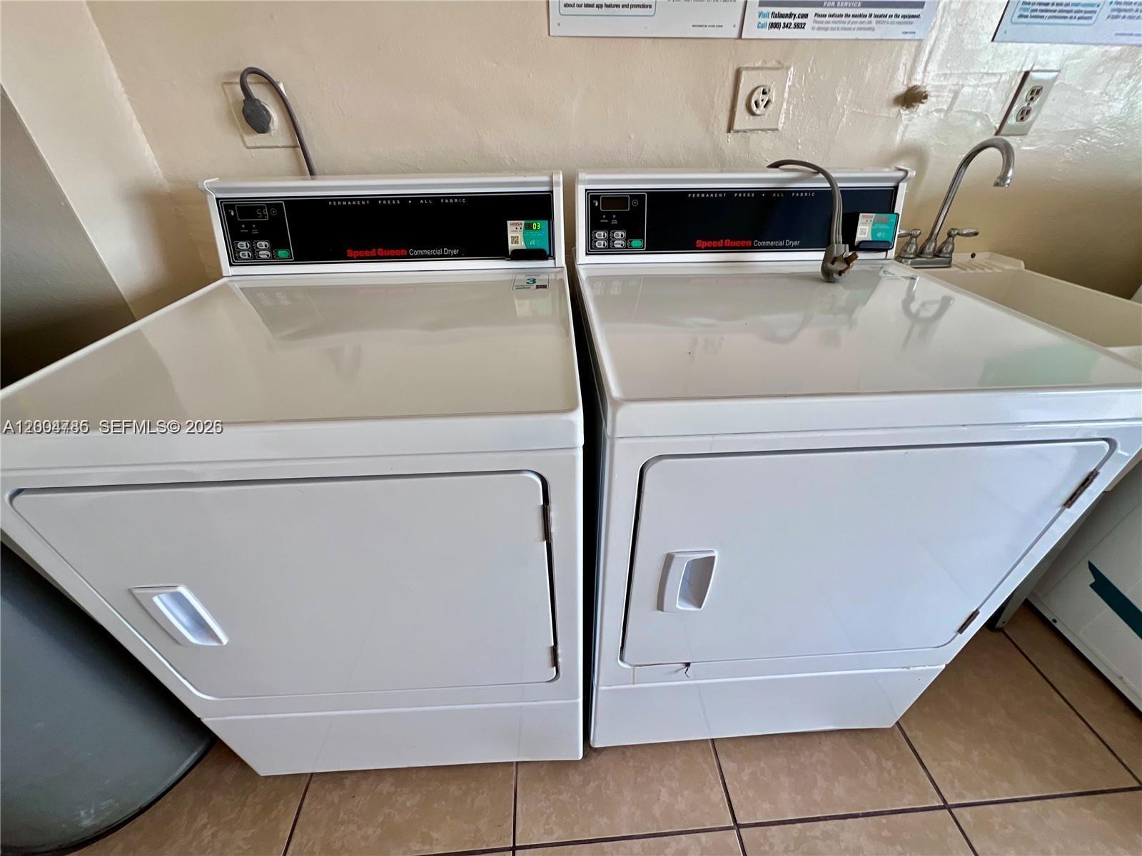 17530 Northwest 68th Avenue, Unit C4008 Hialeah, FL 33015 - Photo 22 of 26 a utility room with washer and dryer