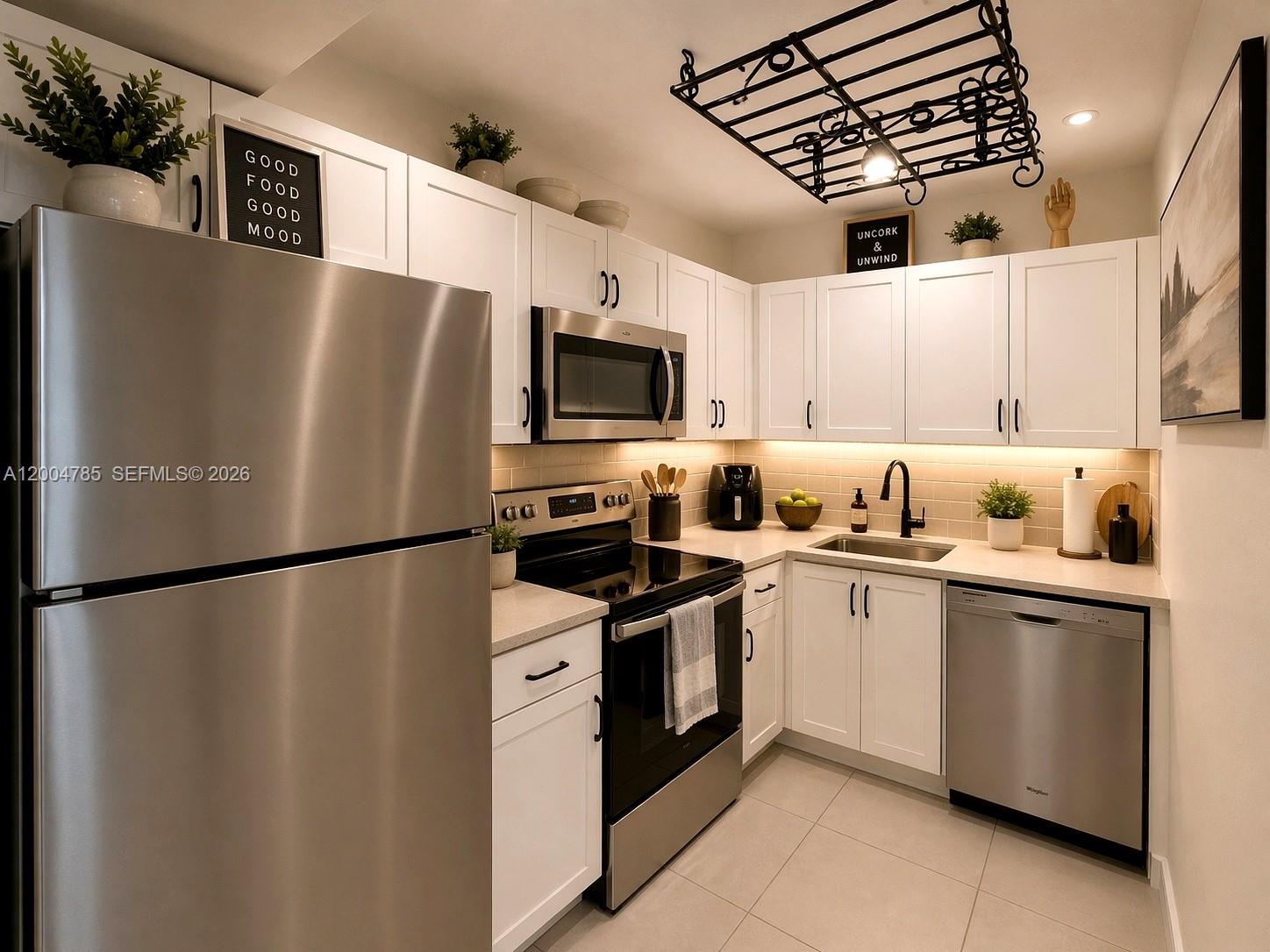 17530 Northwest 68th Avenue, Unit C4008 Hialeah, FL 33015 - Photo 3 of 26 a kitchen with stainless steel appliances granite countertop a refrigerator a stove a sink dishwasher and a refrigerator