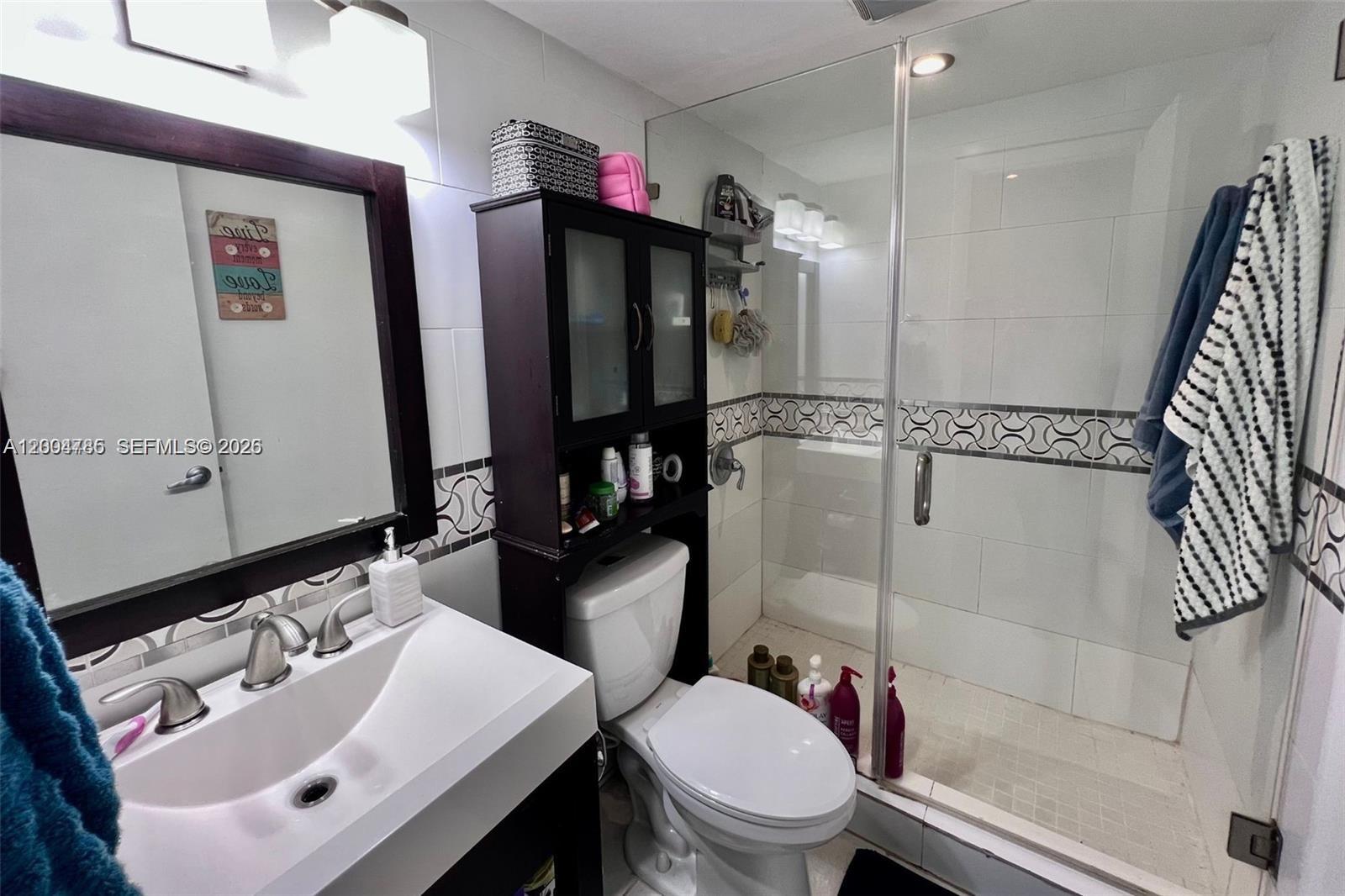 17530 Northwest 68th Avenue, Unit C4008 Hialeah, FL 33015 - Photo 10 of 26 a bathroom with a sink toilet and shower