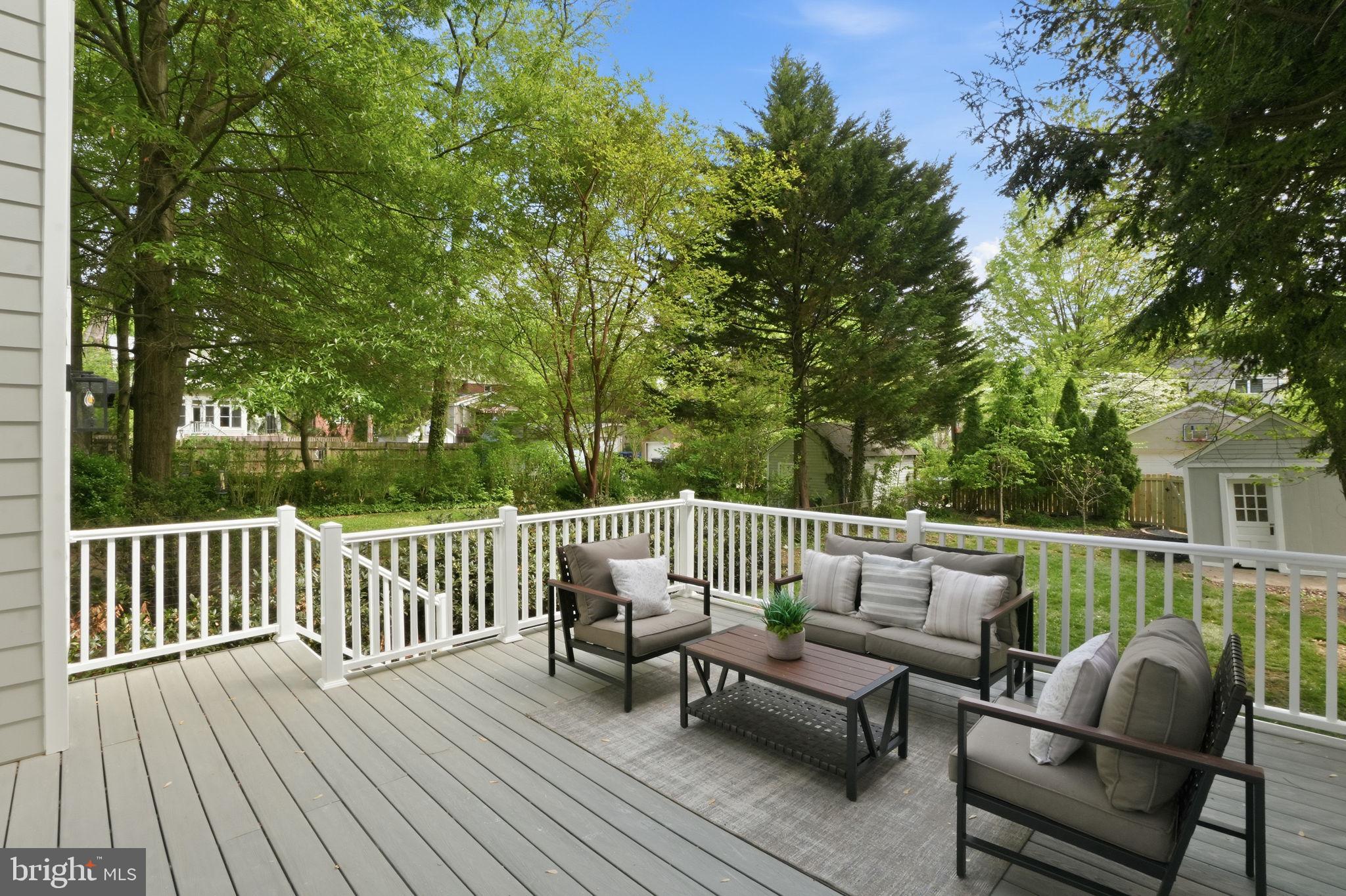 4720 Ellicott Street Northwest Washington, DC 20016 - Photo 16 of 52 a roof deck with couches and wooden fence