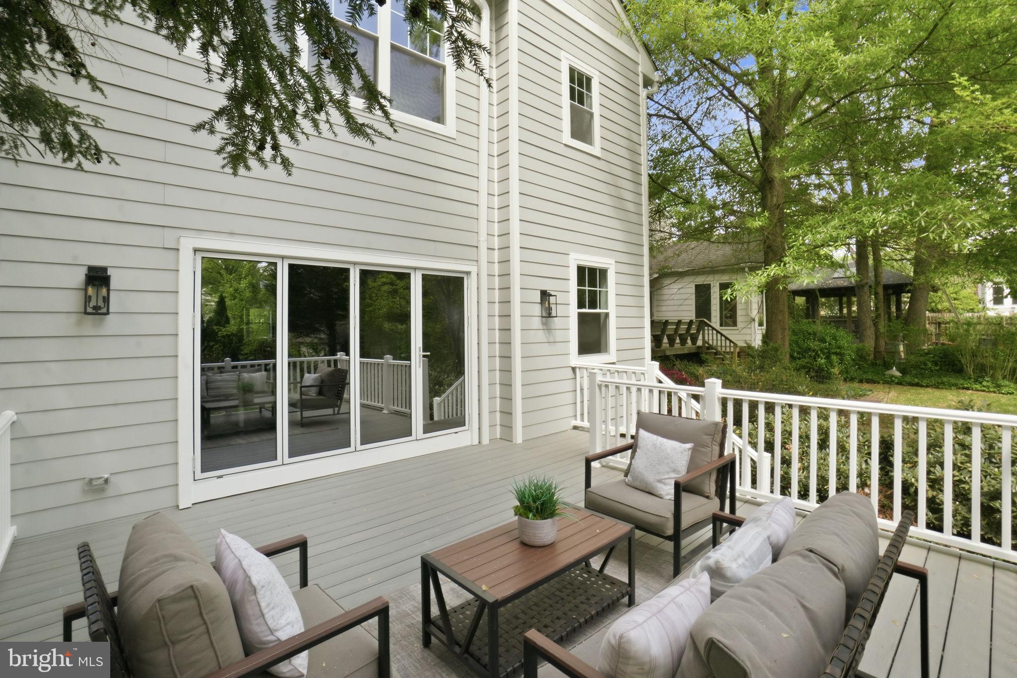 4720 Ellicott Street Northwest Washington, DC 20016 - Photo 17 of 52 a view of a house with a bench in a patio