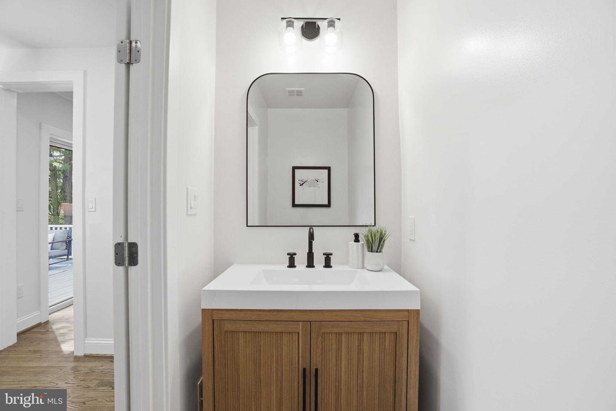 4720 Ellicott Street Northwest Washington, DC 20016 - Photo 18 of 52 a bathroom with a sink and a mirror