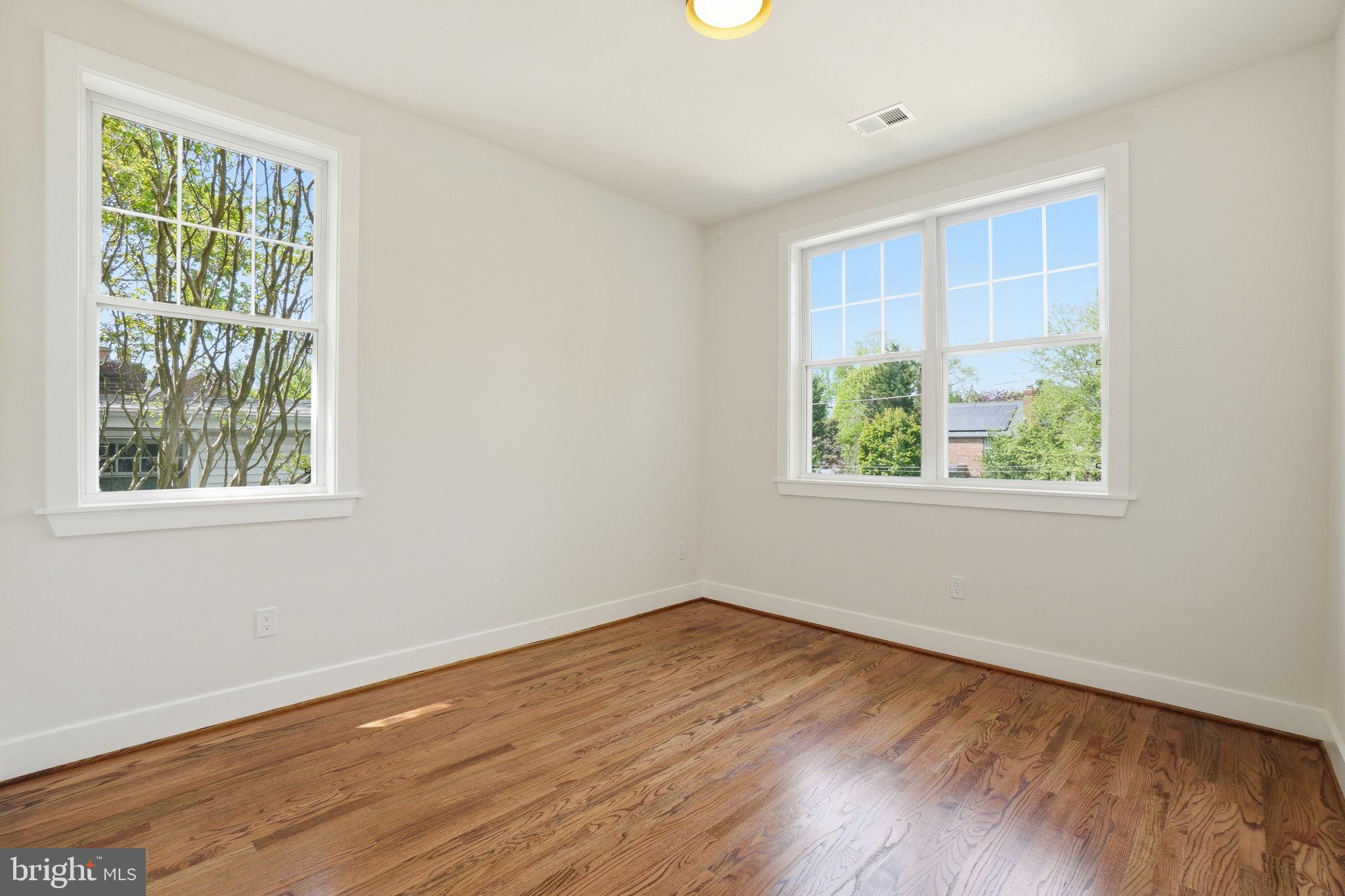 4720 Ellicott Street Northwest Washington, DC 20016 - Photo 27 of 52 an empty room with wooden floor and windows