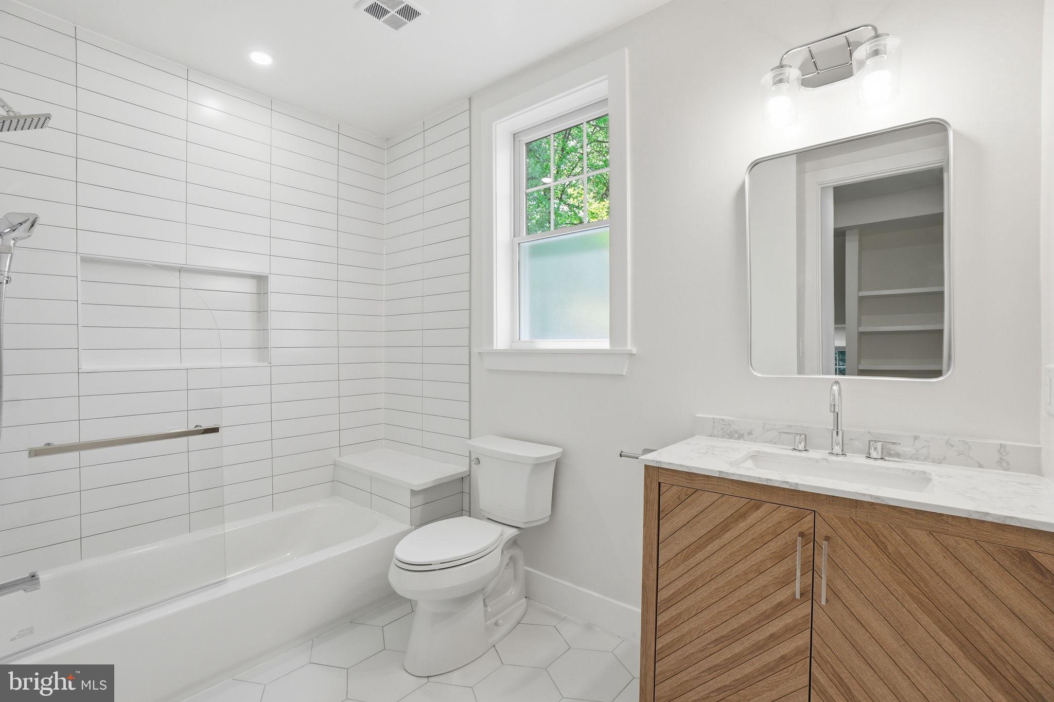 4720 Ellicott Street Northwest Washington, DC 20016 - Photo 29 of 52 a bathroom with a sink a toilet and bathtub
