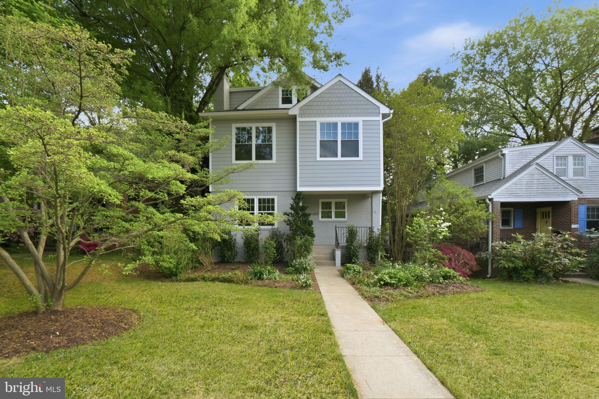 4720 Ellicott Street Northwest Washington, DC 20016 - Photo 3 of 52 a front view of a house with a yard