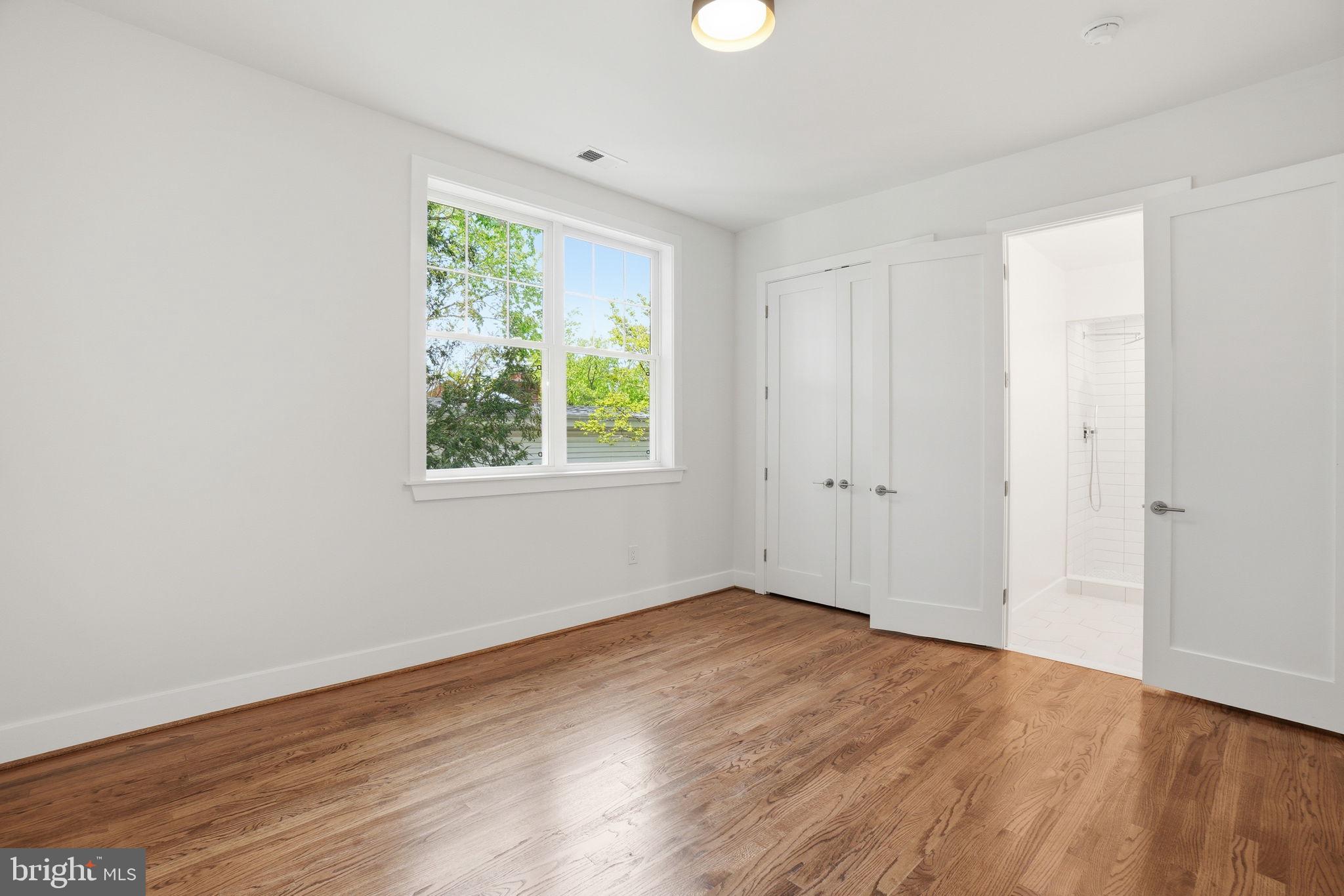 4720 Ellicott Street Northwest Washington, DC 20016 - Photo 33 of 52 a view of an empty room with wooden floor and a window