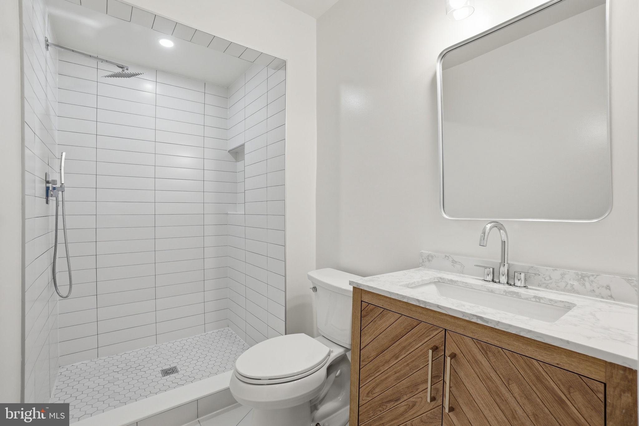 4720 Ellicott Street Northwest Washington, DC 20016 - Photo 34 of 52 a bathroom with a sink toilet and shower