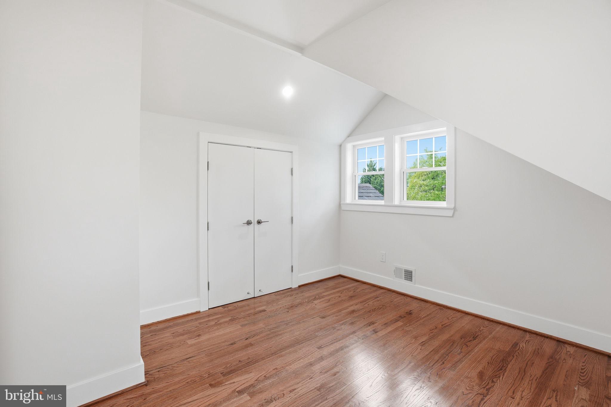 4720 Ellicott Street Northwest Washington, DC 20016 - Photo 35 of 52 an empty room with wooden floor and windows