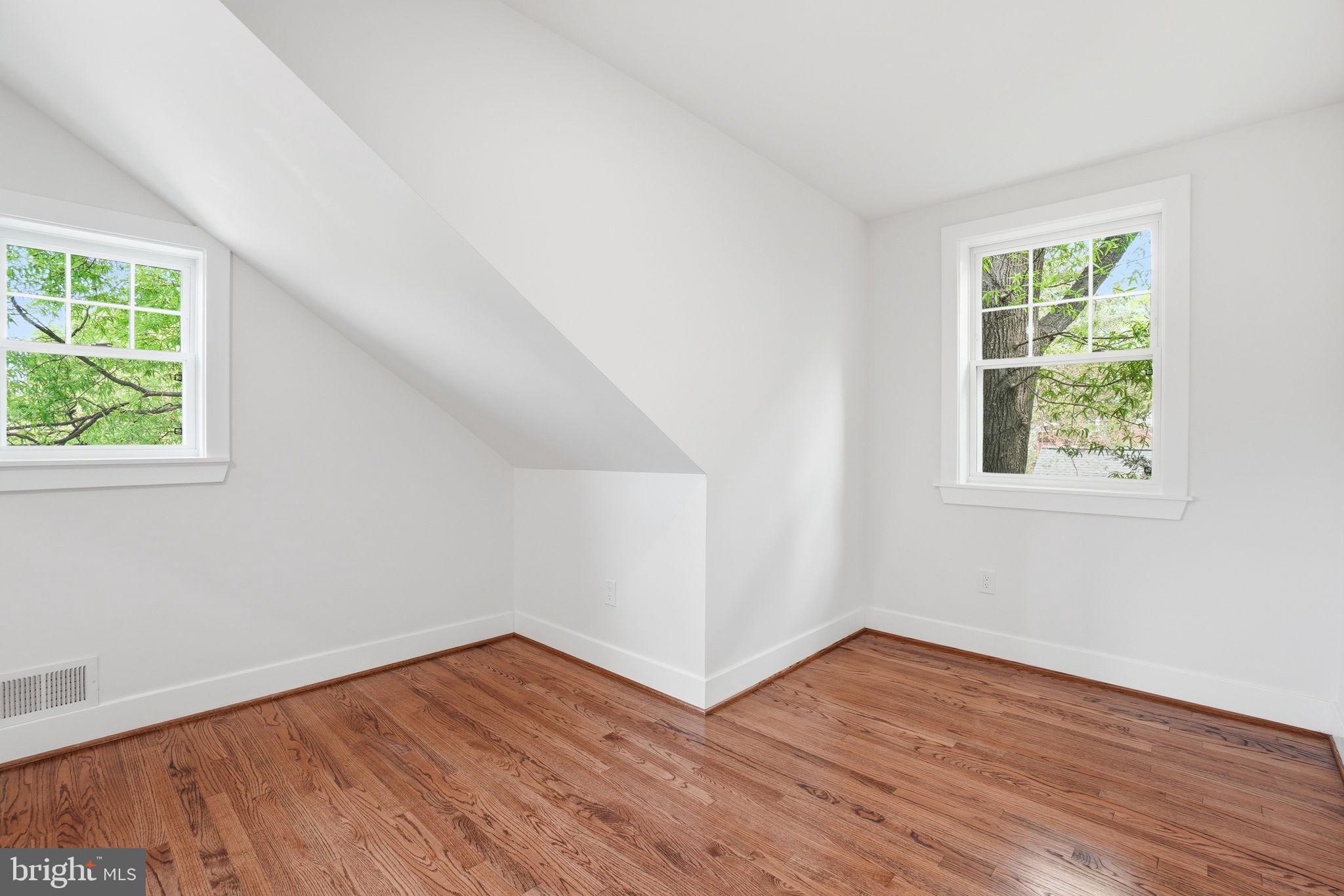 4720 Ellicott Street Northwest Washington, DC 20016 - Photo 36 of 52 an empty room with wooden floor and windows