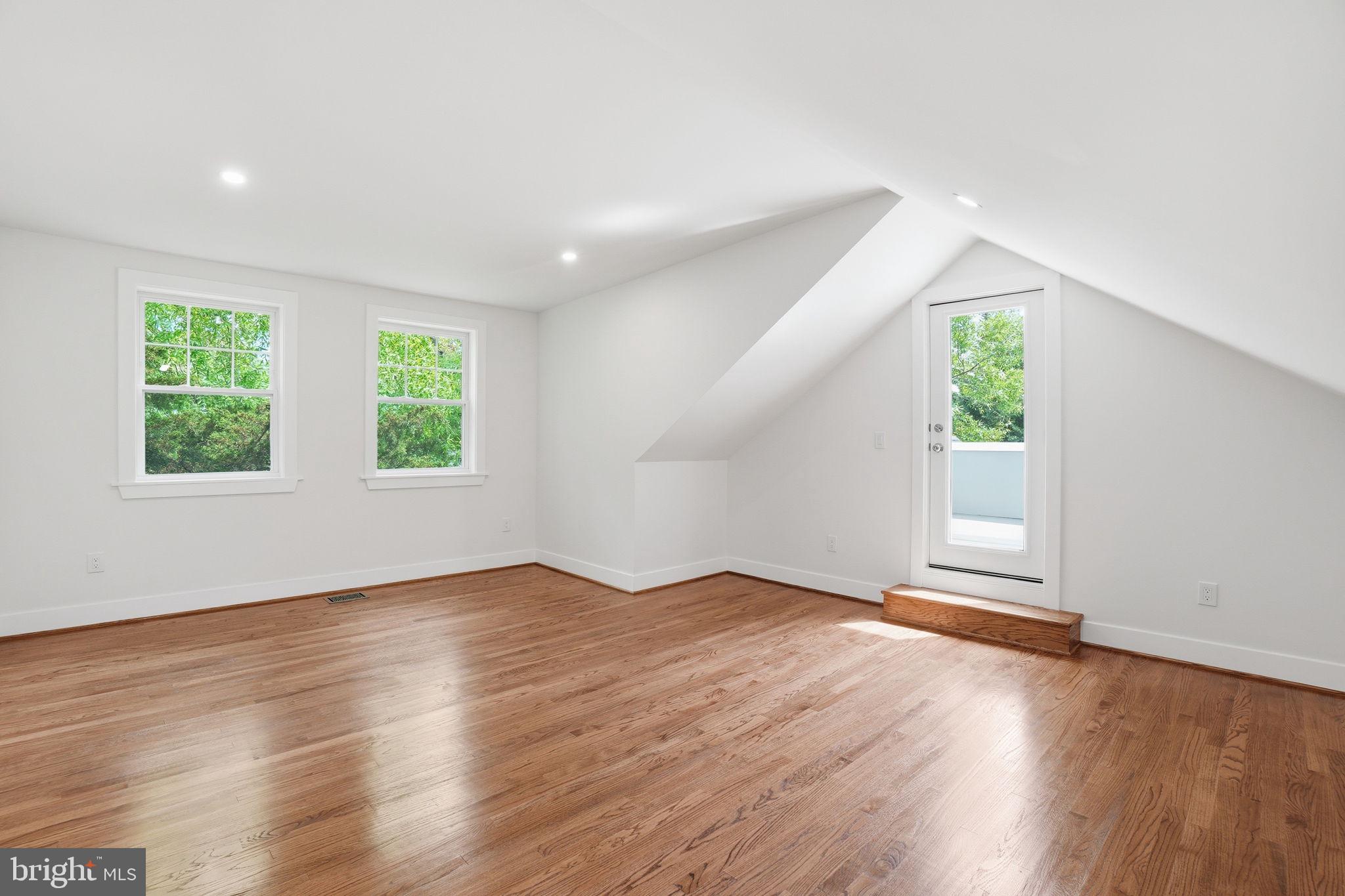 4720 Ellicott Street Northwest Washington, DC 20016 - Photo 39 of 52 an empty room with wooden floor and windows