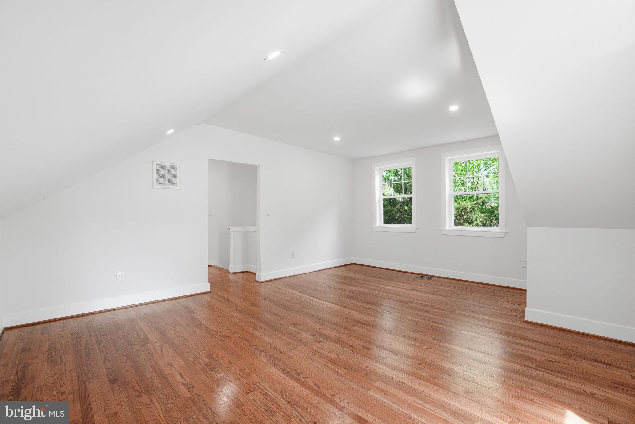 4720 Ellicott Street Northwest Washington, DC 20016 - Photo 40 of 52 an empty room with wooden floor and windows