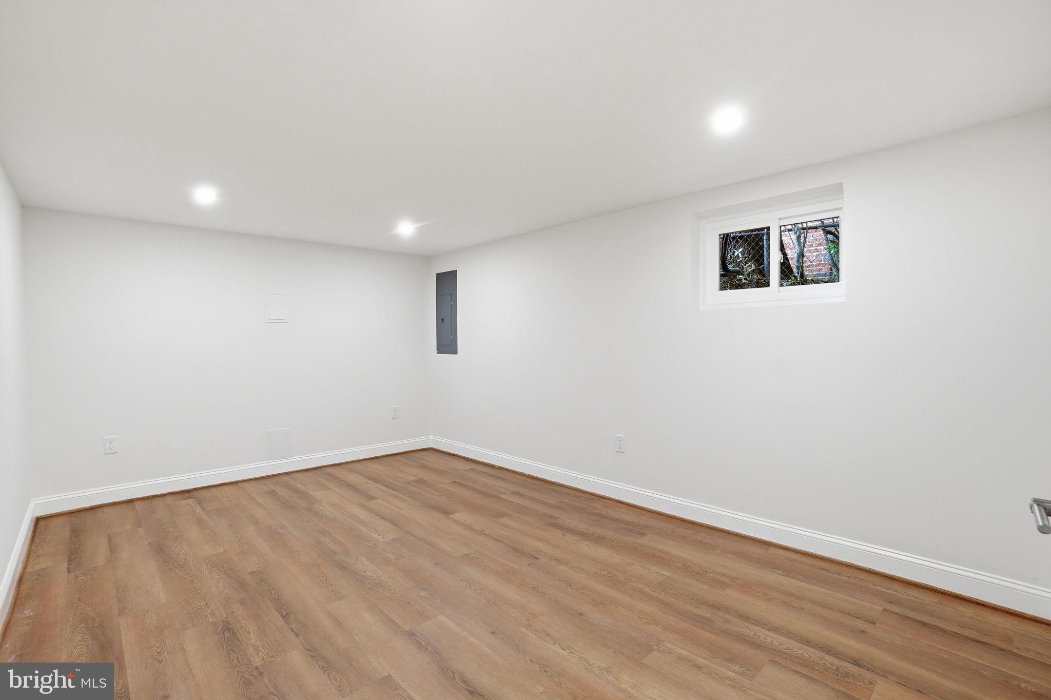4720 Ellicott Street Northwest Washington, DC 20016 - Photo 45 of 52 an empty room with wooden floor and windows
