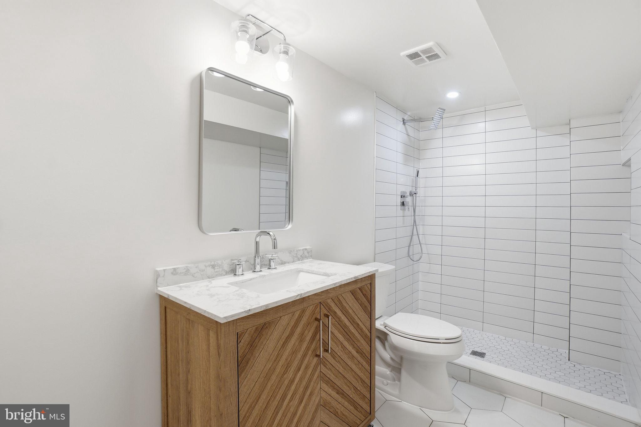 4720 Ellicott Street Northwest Washington, DC 20016 - Photo 47 of 52 a bathroom with a sink toilet and shower