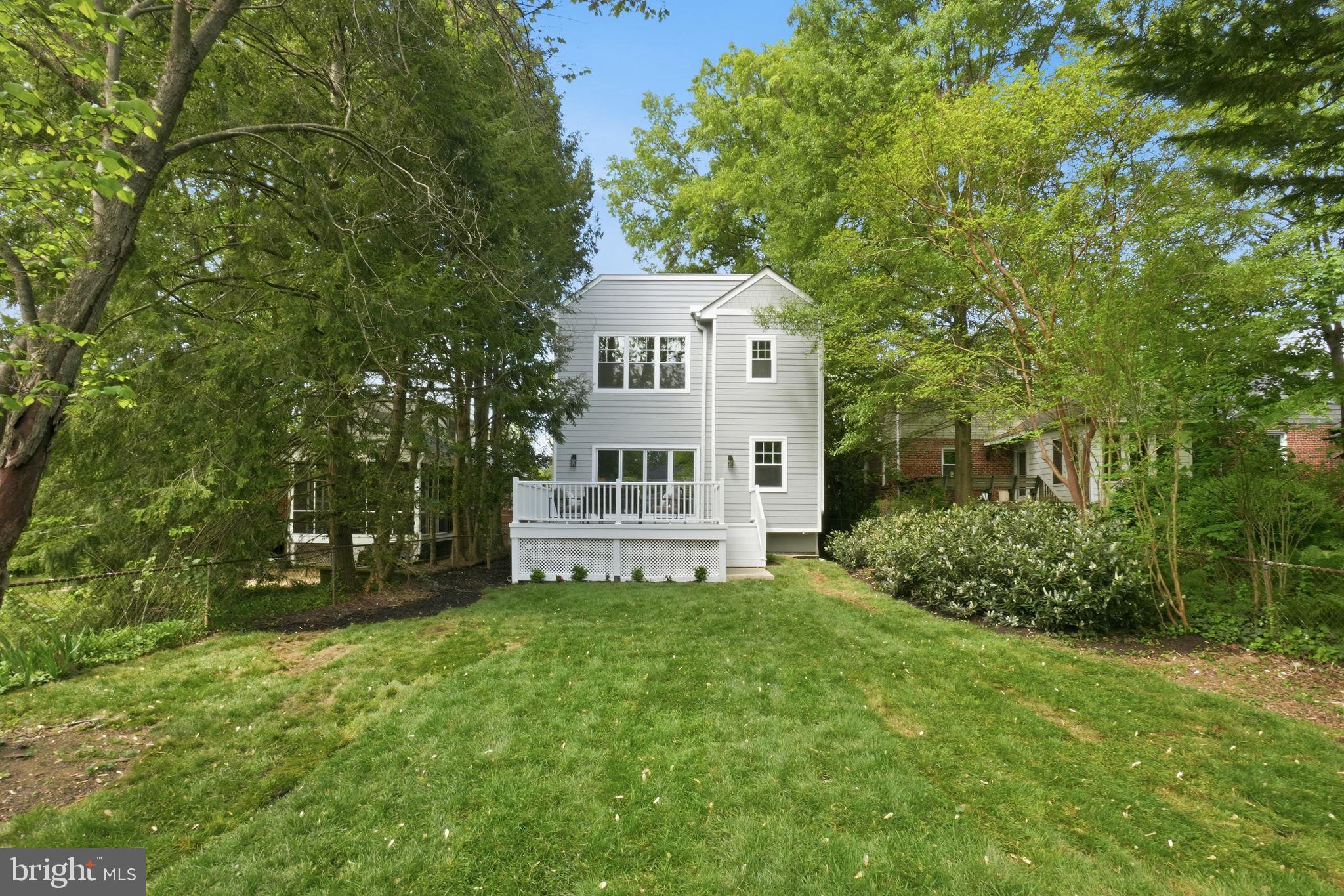 4720 Ellicott Street Northwest Washington, DC 20016 - Photo 51 of 52 a view of a house with a big yard and large trees
