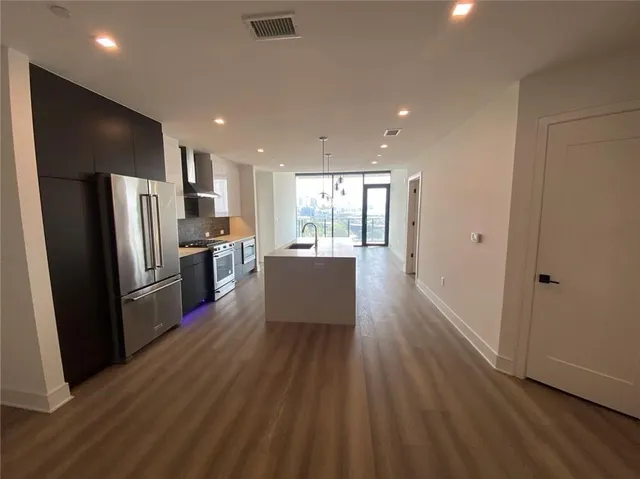 a kitchen with a refrigerator and a sink