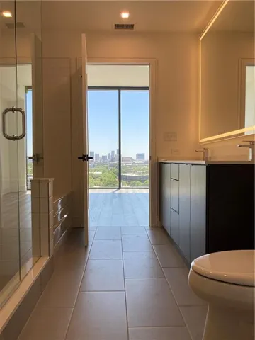 a bathroom with a glass shower door and a bathtub