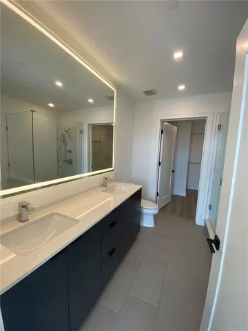 a bathroom with a double vanity sink and mirror
