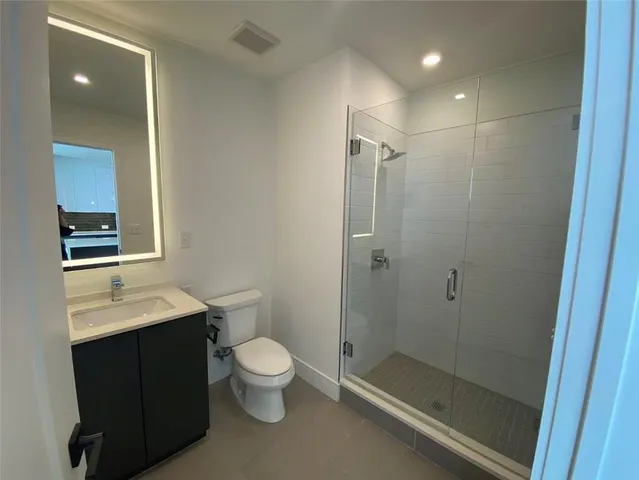 a bathroom with a toilet a sink and shower