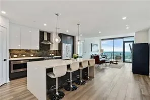 a large kitchen with a table and chairs