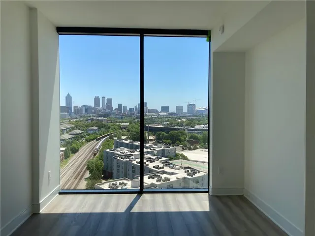 a view of a floor to ceiling window and wooden floor