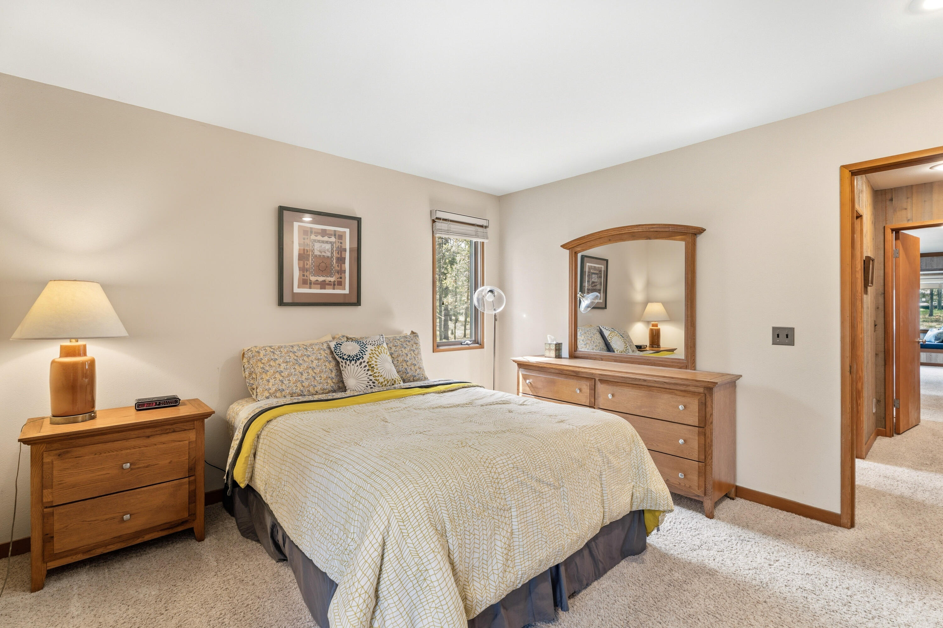 17866 Grouse Lane, Unit 3 Sunriver, OR 97707 - Photo 29 of 61 a bedroom with a bed and a night stand
