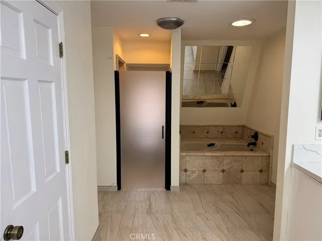 a bathroom with a shower and a glass door