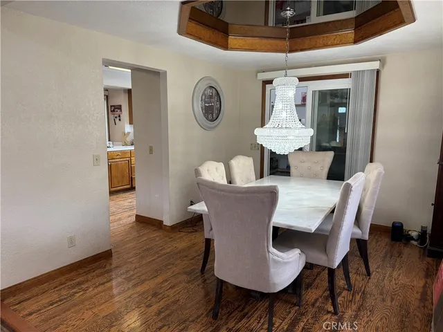 a dining room with furniture and wooden floor