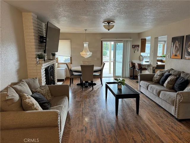 a living room with furniture flat screen tv and wooden floor
