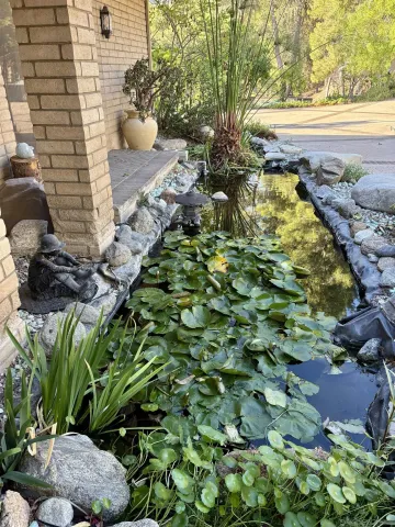 a kitchen with stainless steel appliances granite countertop a refrigerator a stove and a wooden floors