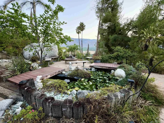 a bathroom with a granite countertop toilet sink and mirror