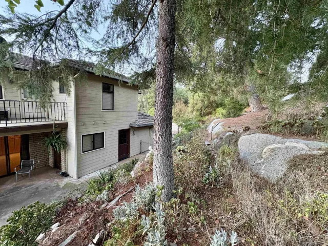 a view of a kitchen with granite countertop a sink and a stove top oven