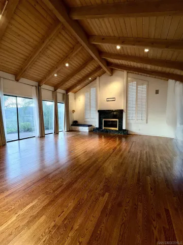 a bedroom with a bed and a flat tv screen on the dresser