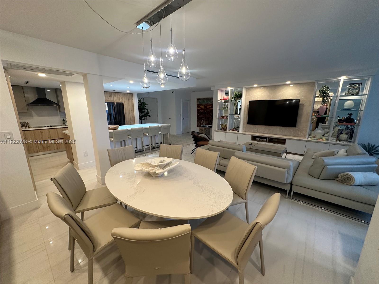 9801 Collins Avenue, Unit 19P Bal Harbour, FL 33154 - Photo 4 of 10 a living room with furniture and a flat screen tv