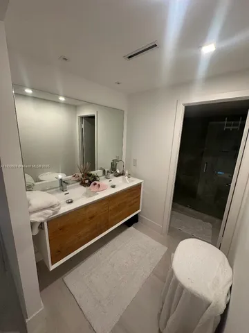 a bathroom with a sink a toilet and mirror