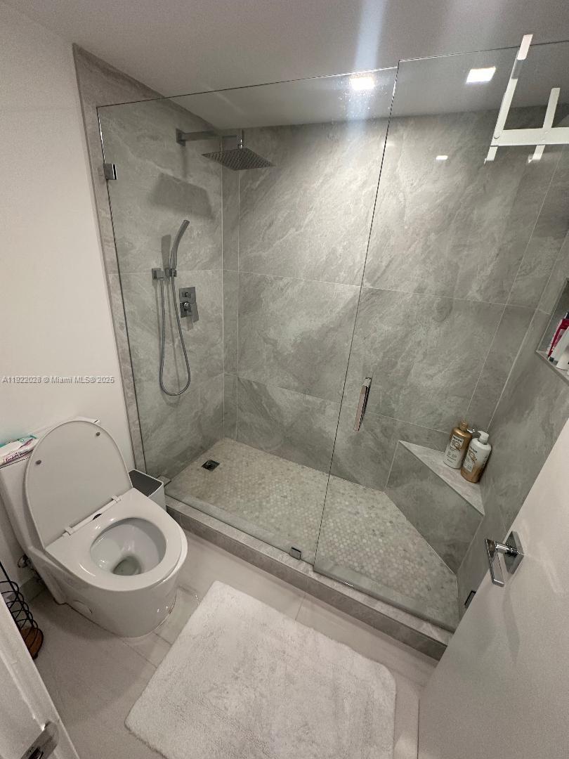 9801 Collins Avenue, Unit 19P Bal Harbour, FL 33154 - Photo 7 of 10 a bathroom with a shower and a toilet