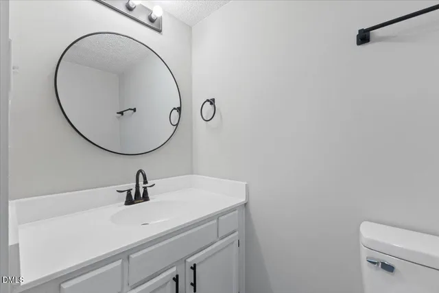 a bathroom with a sink a mirror and vanity