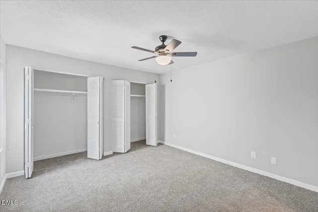 an empty room with fan and a ceiling fan