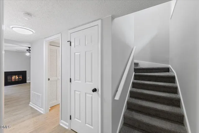 a view of a hallway with wooden floor and entryway