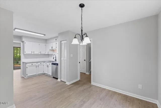 a view of a kitchen with refrigerator stove and cabinets