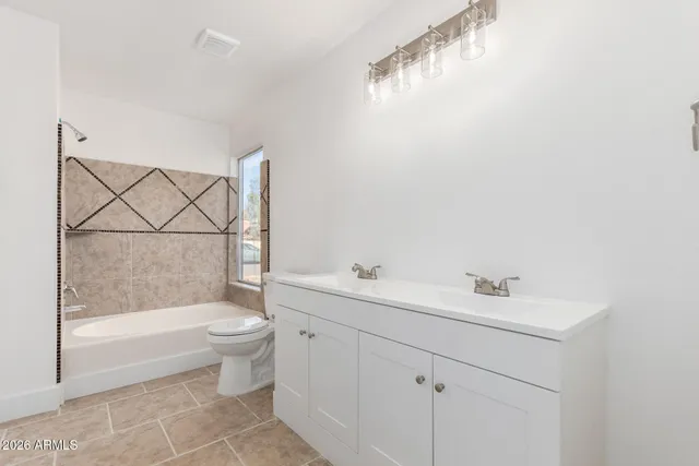 a bathroom with a toilet a sink a mirror a bathtub and shower