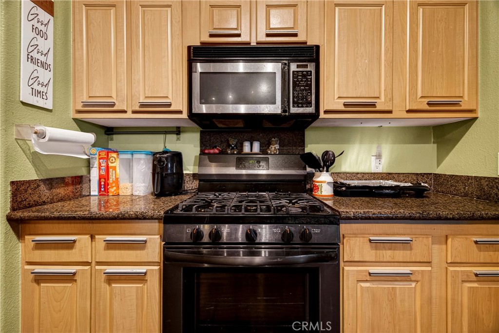 32 Sheldon Avenue Gridley, CA 95948 - Photo 22 of 75 a kitchen with granite countertop a stove and a microwave