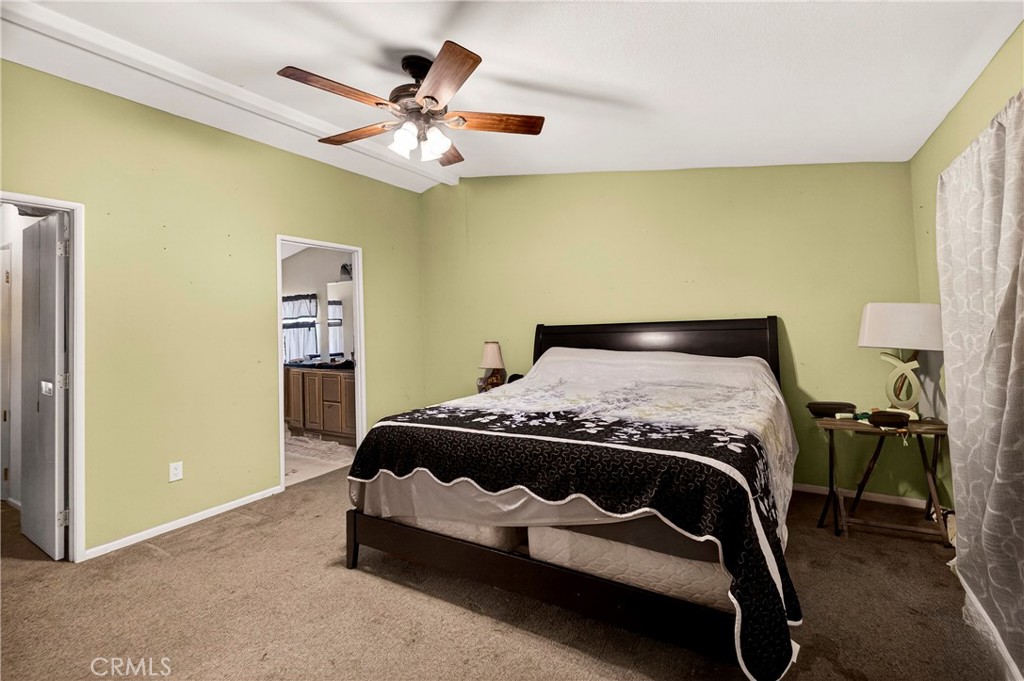 32 Sheldon Avenue Gridley, CA 95948 - Photo 29 of 75 a bedroom with a bed and a chandelier