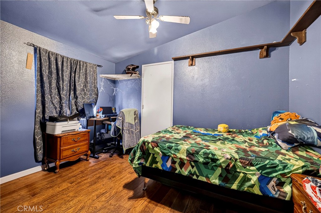 32 Sheldon Avenue Gridley, CA 95948 - Photo 35 of 75 a bedroom with a bed and a chandelier