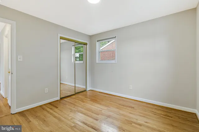 a view of a room with wooden floor and white walls