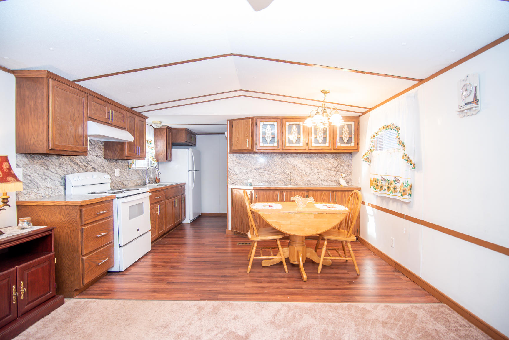 143 Sunset Ridge Road Callaway, VA 24067 - Photo 26 of 42 a dining room with a sink a dining table and chairs