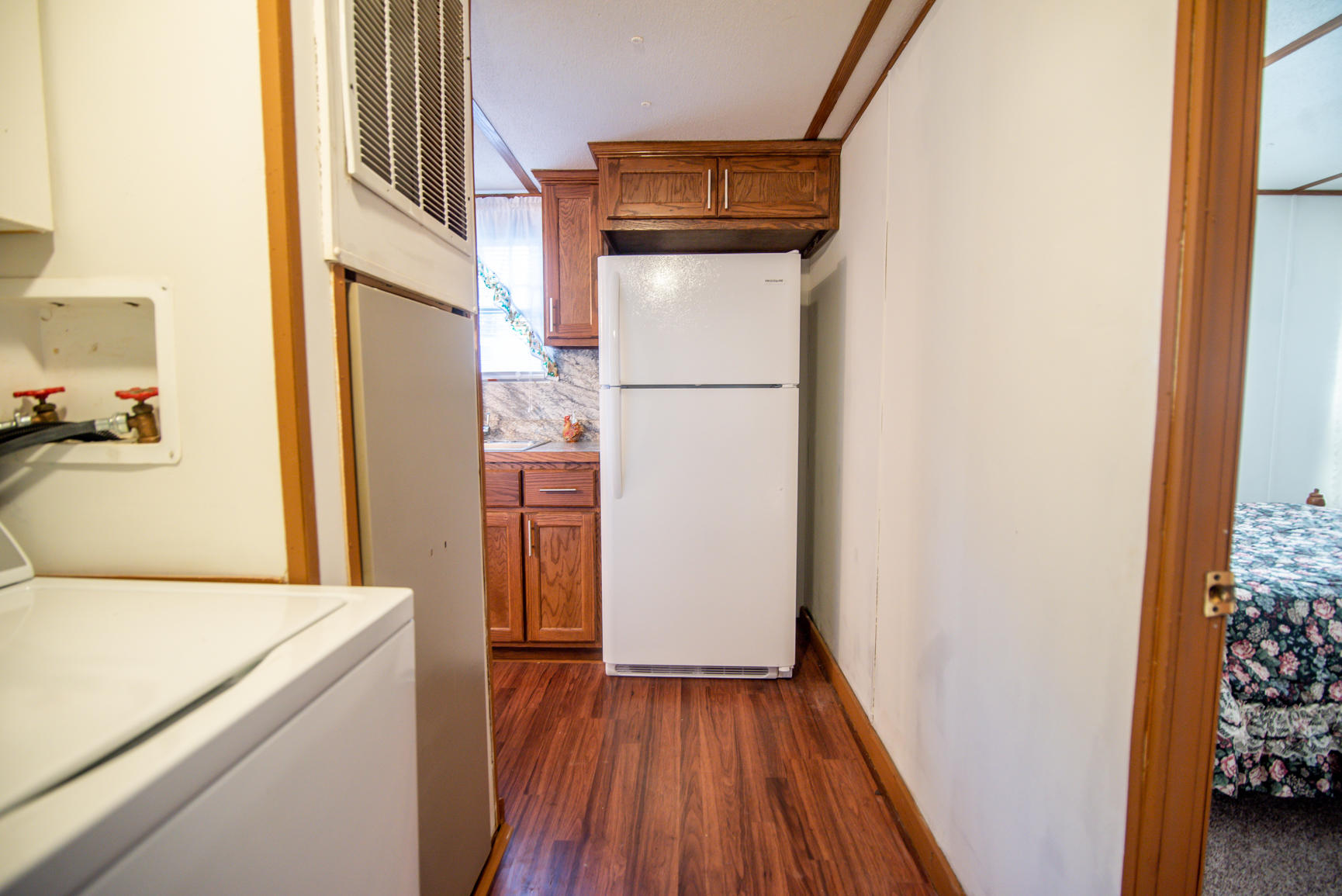 143 Sunset Ridge Road Callaway, VA 24067 - Photo 30 of 42 a kitchen with a refrigerator a stove top oven and wooden floor