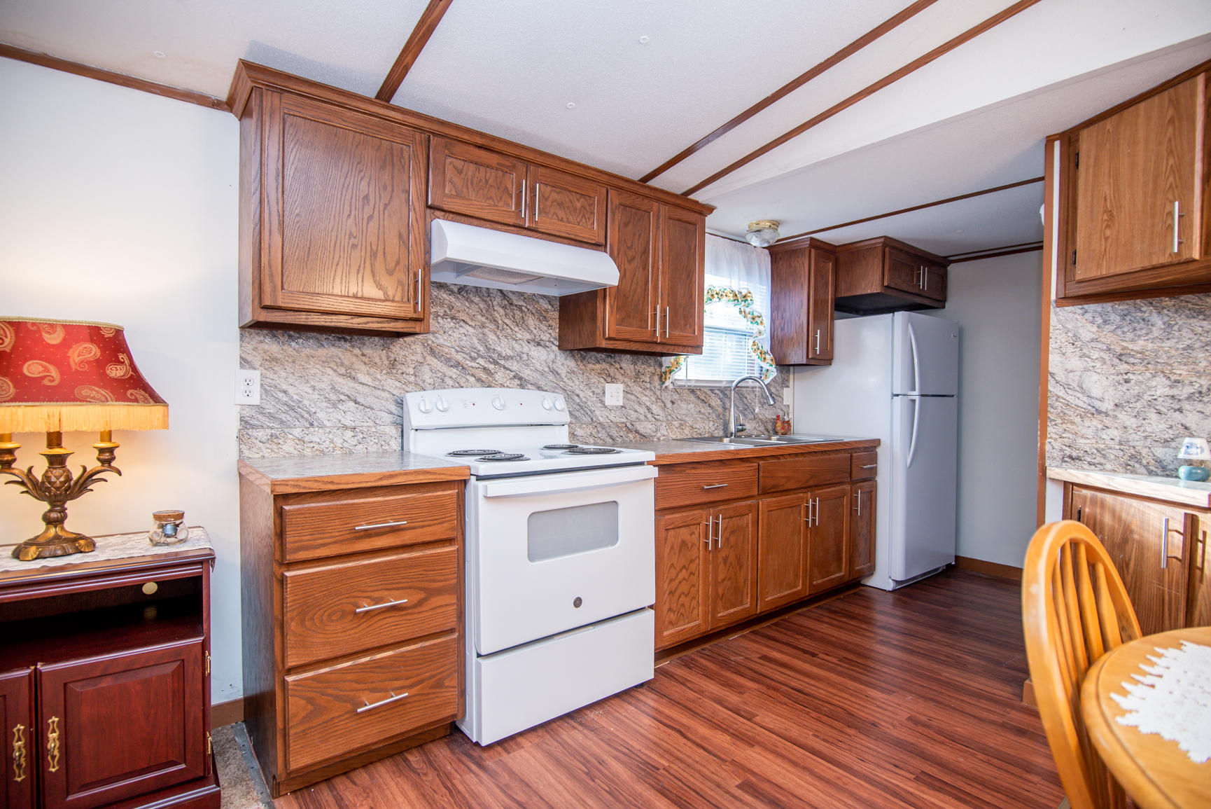 143 Sunset Ridge Road Callaway, VA 24067 - Photo 36 of 42 a kitchen with wooden floors and wooden cabinets