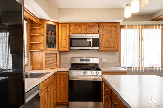 a kitchen with a stove a sink and a microwave