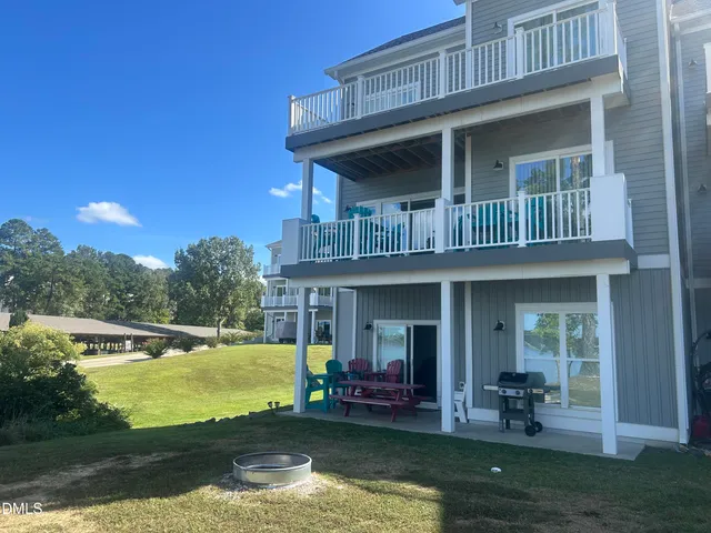 a view of a house with backyard porch and sitting area