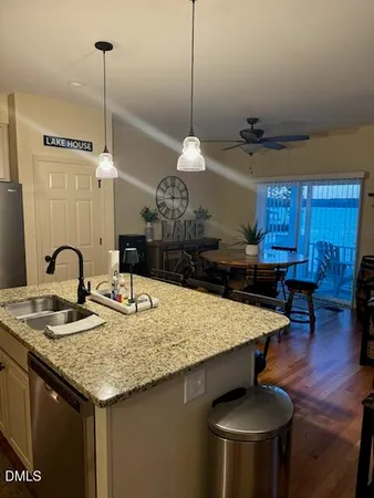 a kitchen with a counter space cabinets and wooden floor
